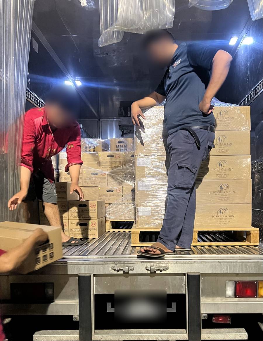 Our team loading palletised Josness & Son boxes into a refrigerated truck