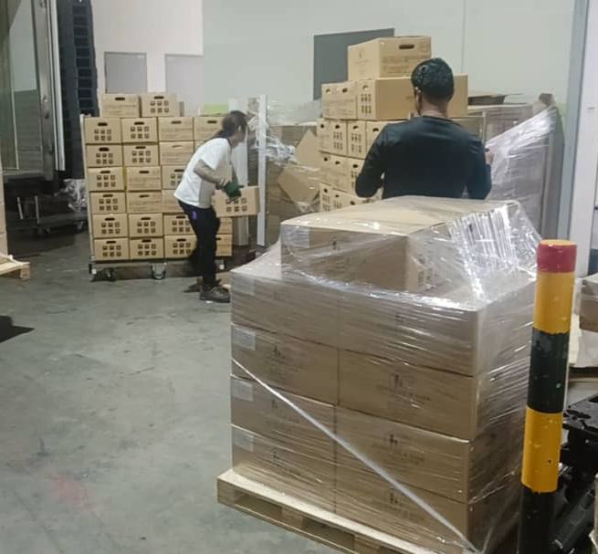 Pallets of boxes being unloaded at a customer's warehouse